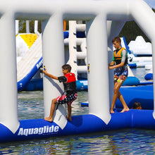 Two children on an inflatable water park structure with 'Aquaglide' branding.