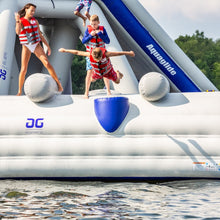 Children playing on an inflatable water toy with 'Aquaglide' branding near a body of water.