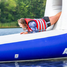 Child in a life jacket on an inflatable boat with a blurred natural background
