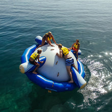Four people on Aquaglide Rockit Circular Water Rocker in the middle of a body of water
