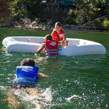 Children in life vests playing in Aquaglide Soaker Lounge on a lake