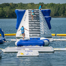 Inflatable water park structure with people on a lake