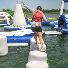Person on an inflatable obstacle course in a water park