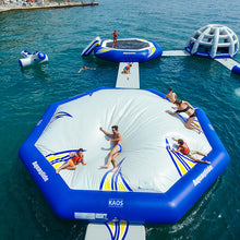 Inflatable water park with people playing on a trampoline in the water