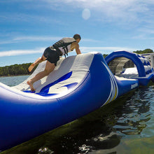Person on an inflatable water slide in a lake on a sunny day