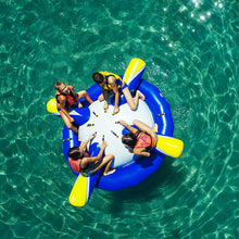 Aquaglide Rockit Jr Circular Water Rocker floating on clear turquoise water.
