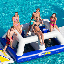 Group of people on an inflatable water toy in a pool