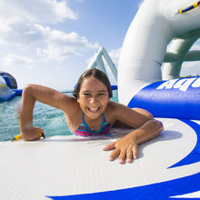 Child on an Aquaglide Speedway 10 with a blue sky and water background