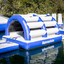 Inflatable water obstacle course with blue and white colors on a body of water.