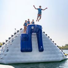 Children playing on an inflatable water slide in a lake