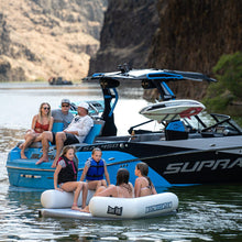 Group of people on a boat with mountains in the background