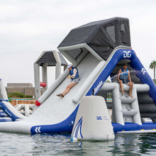 Inflatable water slide structure with people on a body of water