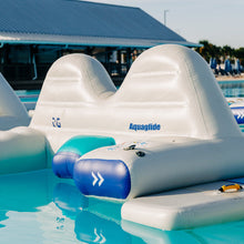 Inflatable water toys with Aquaglide branding in a pool setting