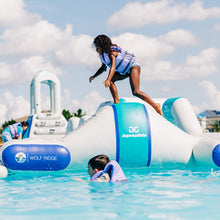 Children playing on an inflatable water park with Aquaglide branding.