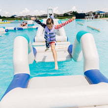 Child playing on an inflatable water toy in a pool