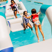 Children playing on an inflatable water slide in a pool