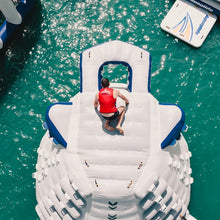 Person on an inflatable water slide in a pool