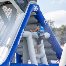 Person climbing an inflatable water slide.