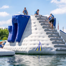 Inflatable water slide with people on a sunny day