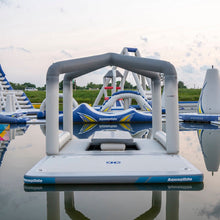 Inflatable water toys on a pool with 'AquaGlide' branding.