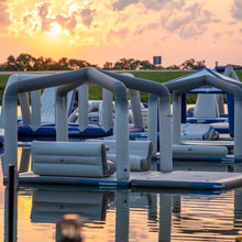 Aquaglide Ohana Lounge, with warm orange sky reflections and distant trees in the background.