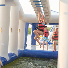 Children playing on an inflatable water slide with a pool below