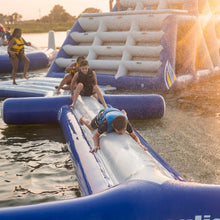 Children playing on an Aquaglide I-BEAM 20 in a lake during sunset.
