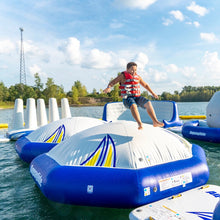 Person on an inflatable water obstacle course with a scenic background