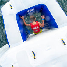 Person in a red life jacket on an inflatable raft in water