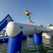 Person on an inflatable water obstacle course.