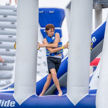 Person on an inflatable slide with blue and white structure