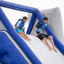 Two children sliding down an inflatable water slide with blue and gray colors.