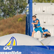 Child playing on inflatable obstacles in an outdoor setting
