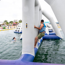 Person climbing on an inflatable water structure in a pool