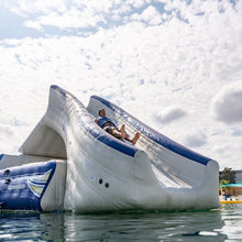 Inflatable water slide in the water with a cloudy sky background