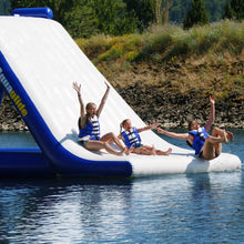 Inflatable water slide with people on a lake