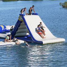 Inflatable water slide on a lake with people enjoying the activity