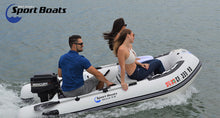 Two people on a Sport Boats inflatable boat with a motor, on a body of water.