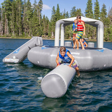 Gray inflatable water park structure on a lake with children playing