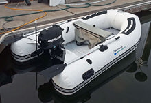 Island Hopper Manta Ray 8.8' Inflatable Fishing Boat and a black Mercury outboard motor, docked on calm water at a wooden pier.