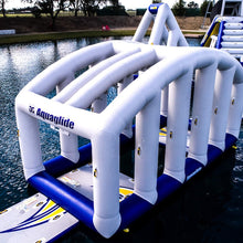Inflatable water obstacle course with Aquaglide branding on a body of water.