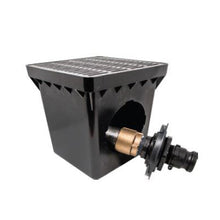 Black metal drain cover with a brass fitting on a white background