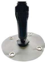 Black cylindrical object on a metallic circular base with screws