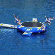 Inflatable water trampoline with people jumping on it over blue water