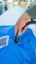 A close-up of a person's hand connecting Island Hopper Inflatable Bull Shark Bumper Fender