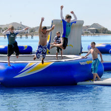 Children jumping off Aquaglide Water Trampoline Supertramp 23 on a sunny day.