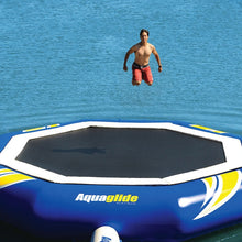 Person jumping off an Aquaglide inflatable trampoline into water