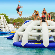 Children playing on an inflatable water park structure with 'Aqua Glide' branding in a pool.