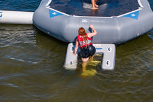 Inflatable platform with people on a body of water