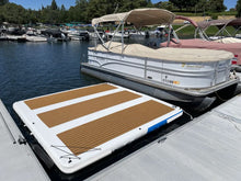 Island Hopper Mega Yacht Dock 10 x 10 ft Inflatable Water Island Platform attached to a white pontoon boat at a marina dock.